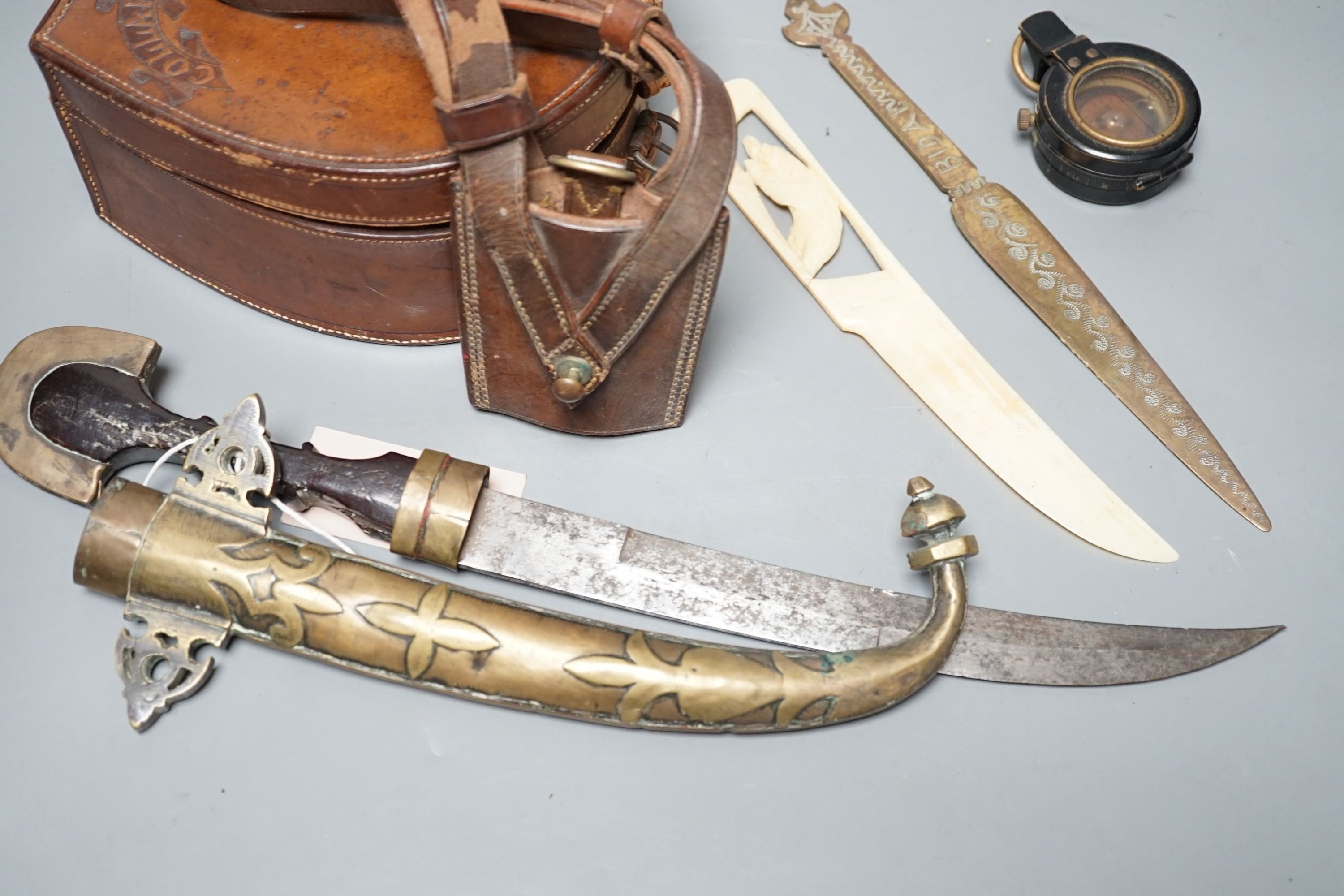 An Eastern dagger, in sheath, leather collars box, cased early 20th century Dollond compass and three others